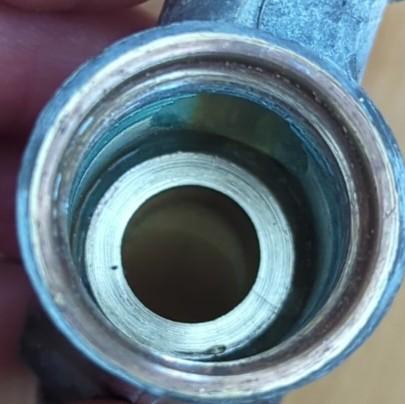 Finished repair, corrosion pits have been removed, leaving smooth brass valve seat.