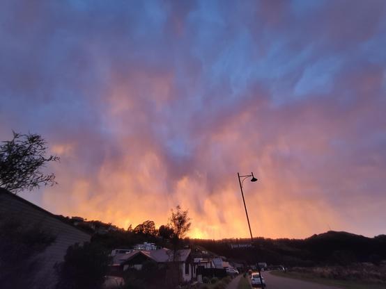 Another view of sunrise over the hills with pink, salmon, orange, & purple hues. 