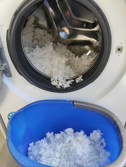 Bucket in front of the washer into which I'm emptying the foam scraps. Becoming more optimistic this might end well for my favourite pillow... 